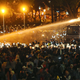 Police use water cannons to disperse demonstrators.